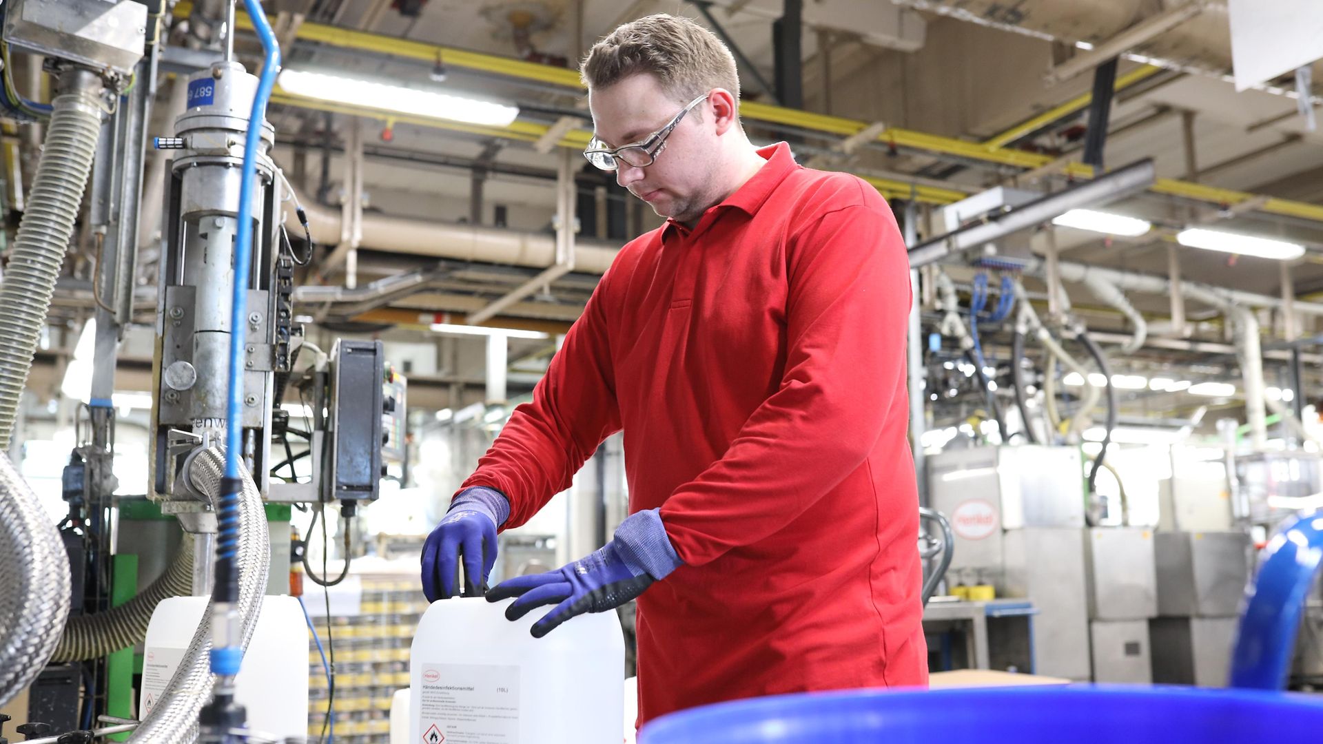 Henkel Employee filling up a canister with disinfectants