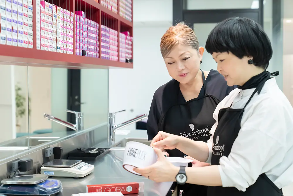 Two evaluators test the performance of hair color products at the product evaluation studio.